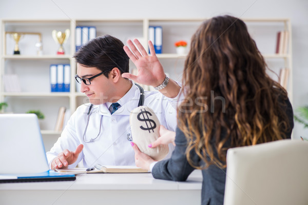 Young doctor in medical insurance fraud concept Stock photo © Elnur