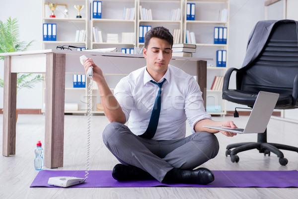 Man meditating in the office to cope with stress Stock photo © Elnur