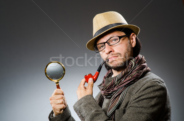 Funny detective with smoking pipe and magnifying glass Stock photo © Elnur