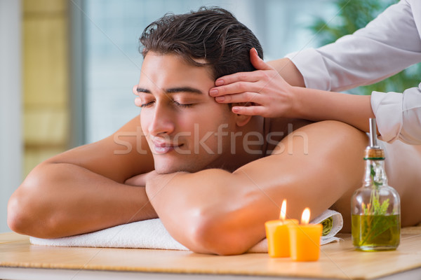 Handsome man during spa massaging session Stock photo © Elnur