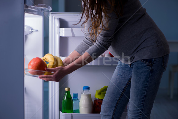 Pregnant woman near fridge looking for food and snacks at night Stock photo © Elnur