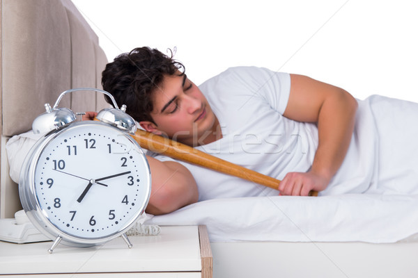 Homem cama sofrimento insônia relógio beisebol Foto stock © Elnur