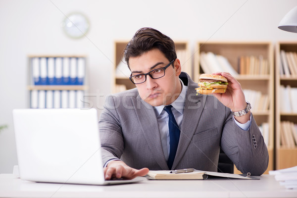 Stock photo: Hungry funny businessman eating junk food sandwich