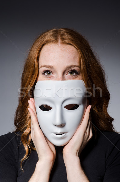 Stock photo: Redhead woman iwith mask in hypocrisy consept against grey backg