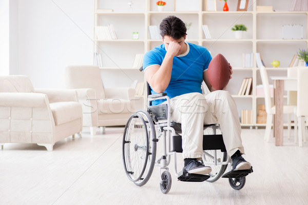 Young man american football player recovering on wheelchair Stock photo © Elnur