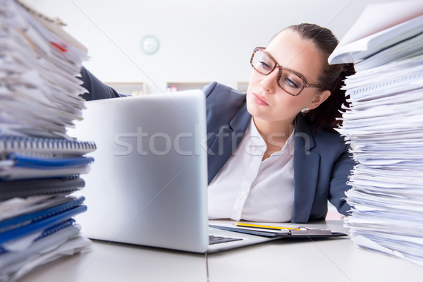 Tired businesswoman with paperwork workload Stock photo © Elnur