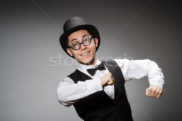 Young man in classical black vest and hat against gray Stock photo © Elnur