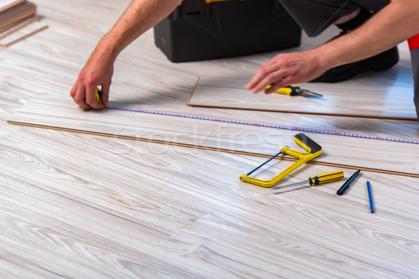 Man laying laminate flooring in construction concept Stock photo © Elnur