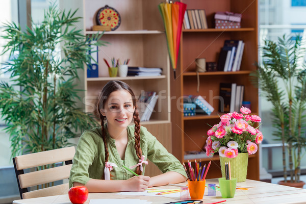 The young girl drawing pictures at home Stock photo © Elnur