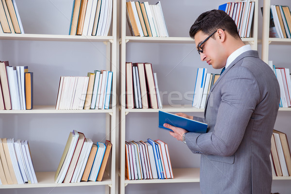 Businessman student reading a book studying in library Stock photo © Elnur