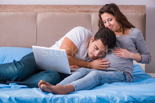 Young family with pregnant wife expecting baby in bed Stock photo © Elnur