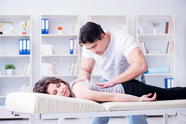 Young doctor chiropractor massaging female patient woman Stock photo © Elnur