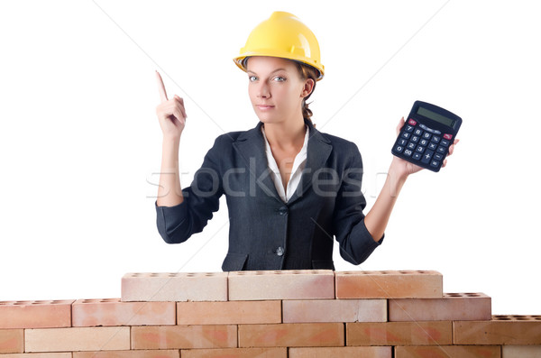 Woman construction worker with calculator on white Stock photo © Elnur