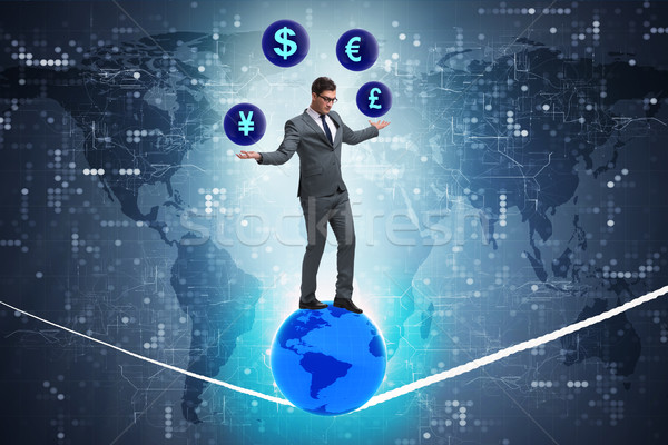 Businessman juggling between various currencies Stock photo © Elnur