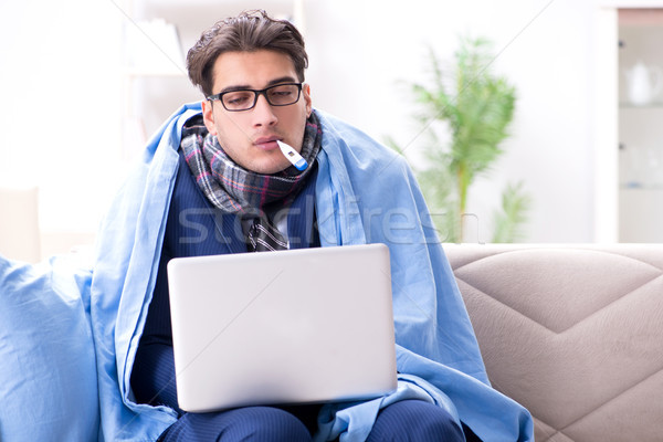 Stock photo: Sick businessman working from home due to flu sickness