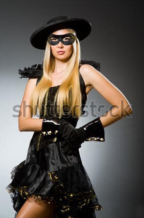 Woman wearing mask against dark background Stock photo © Elnur