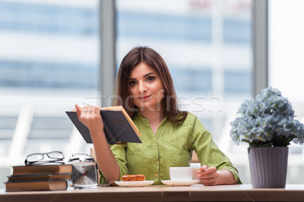 Stock photo: Young student preparing for exams drinking tea