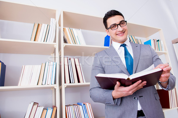 Businessman student reading a book studying in library Stock photo © Elnur