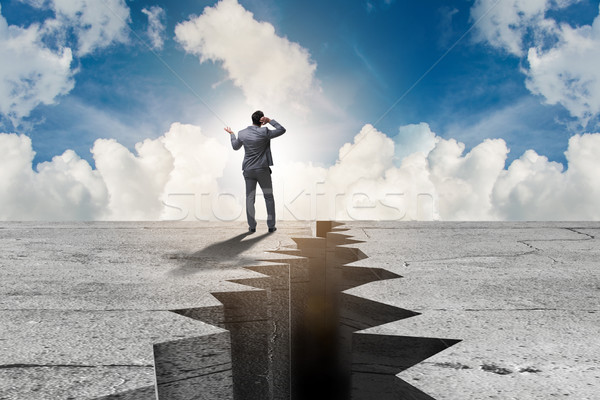 Businessman standing unsure next to cliff Stock photo © Elnur