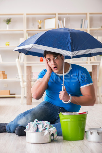 Man at home dealing with neighbor flood leak Stock photo © Elnur