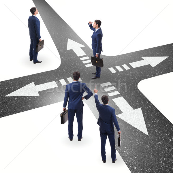 Young businessman at crossroads in uncertainty concept Stock photo © Elnur