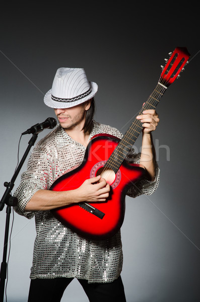 Man with guitar singing with microphone Stock photo © Elnur