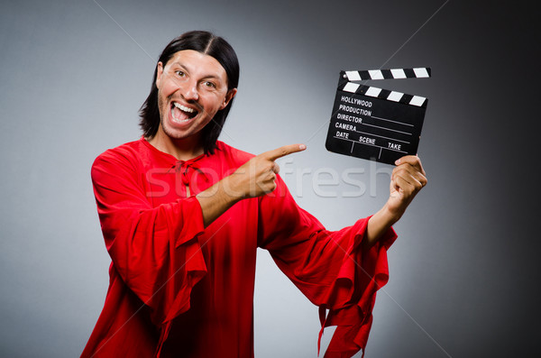 Man in red dress with movie clapboard Stock photo © Elnur