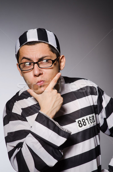 Young prisoner against gray Stock photo © Elnur