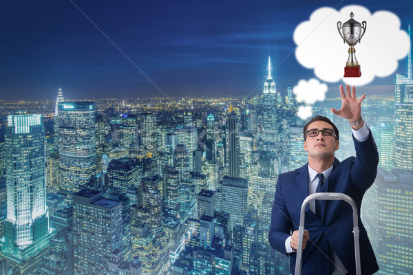 Businessman climbing towards his business goal Stock photo © Elnur