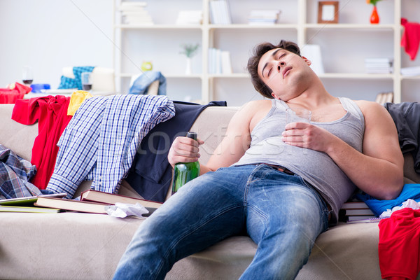 Young man student drunk drinking alcohol in a messy room Stock photo © Elnur