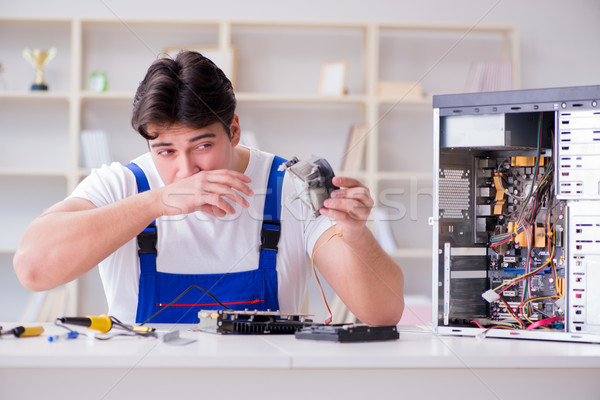 Computer repairman repairing desktop computer Stock photo © Elnur