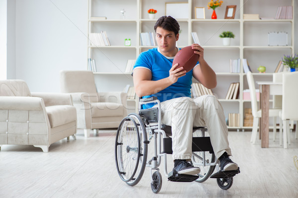 Young man american football player recovering on wheelchair Stock photo © Elnur