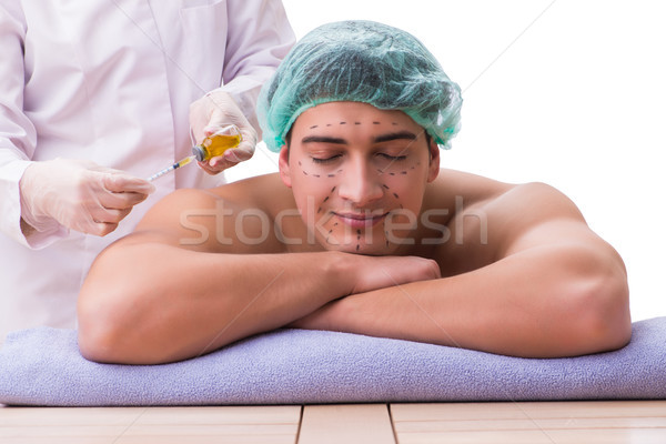 Handsome man in spa massage concept Stock photo © Elnur