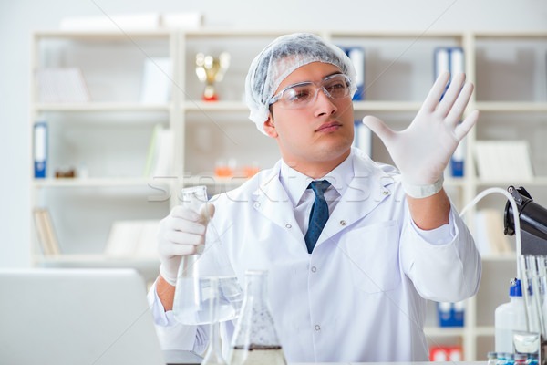 Stock photo: Young researcher scientist doing a water test contamination expe