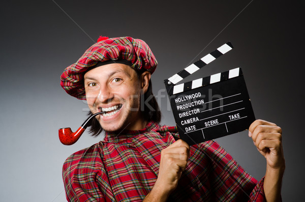 Funny scotsman with movie board and smoking pipe Stock photo © Elnur