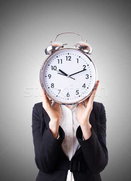 Woman businesswoman with giant clock Stock photo © Elnur