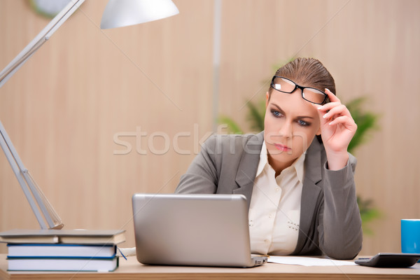Businesswoman under stress from too much work in the office Stock photo © Elnur