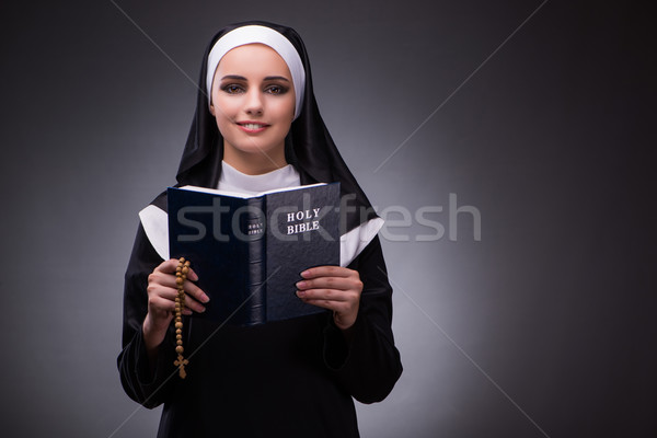 Religious nun in religion concept against dark background Stock photo © Elnur