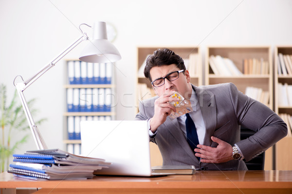 Businessman feeling pain in the office Stock photo © Elnur