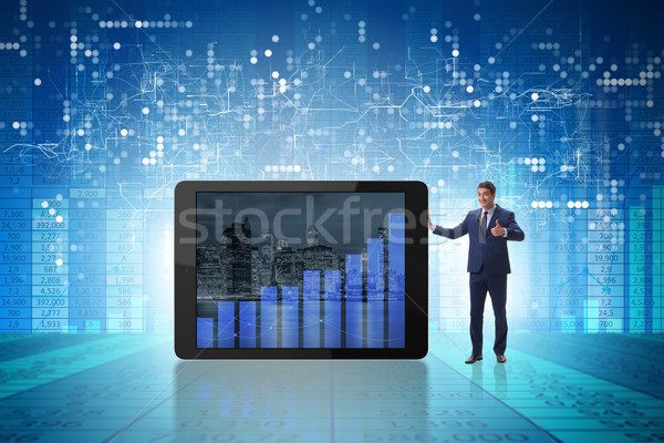Businessman standing next to tablet computer in business concept Stock photo © Elnur