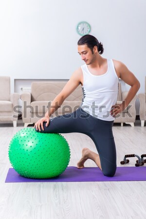 Man with swiss ball doing exercises on white Stock photo © Elnur