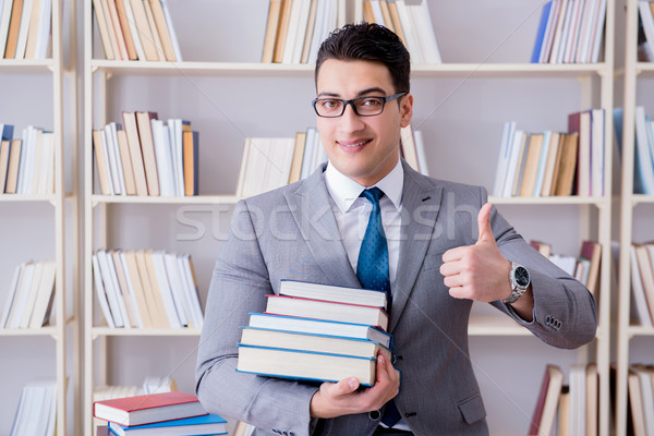 Business law student with pile of books working in library Stock photo © Elnur