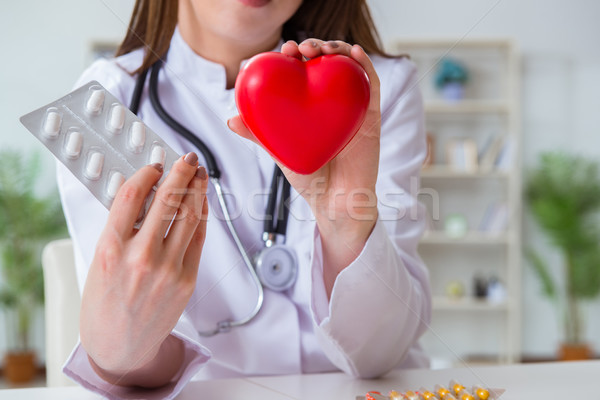 Doctor cardiologist with red heart in the hospital Stock photo © Elnur