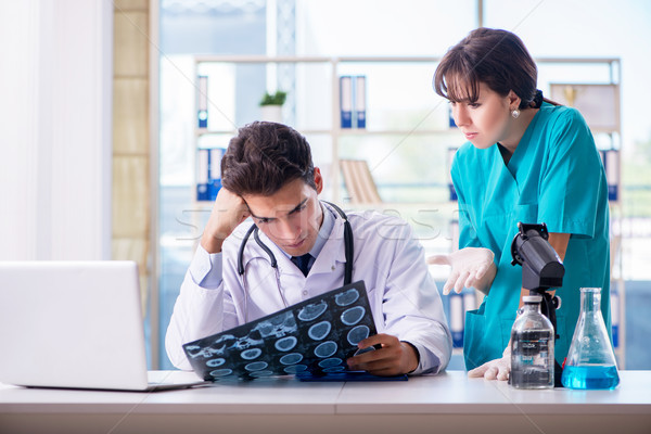 Stock photo: Two doctors discussing x-ray MRI image in hospital