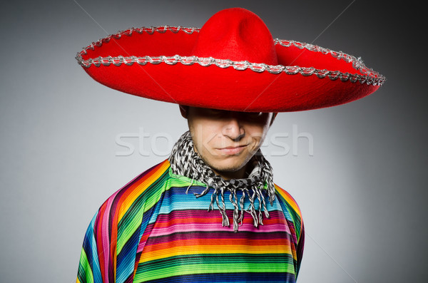 Man in vivid mexican poncho against gray Stock photo © Elnur