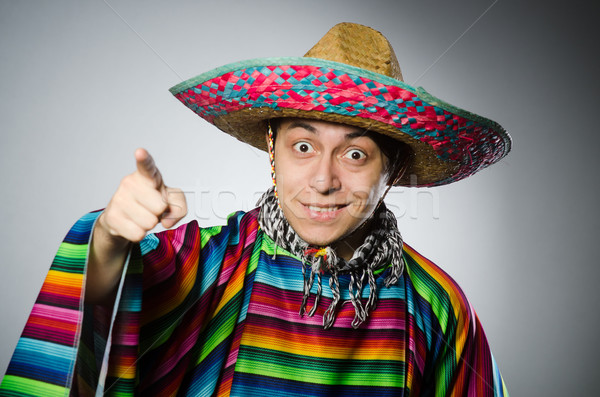 Man in vivid mexican poncho against gray Stock photo © Elnur