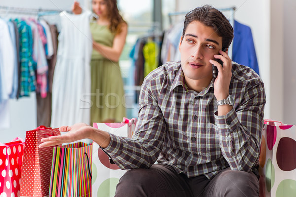 Man fed up with wife shopping in shop Stock photo © Elnur
