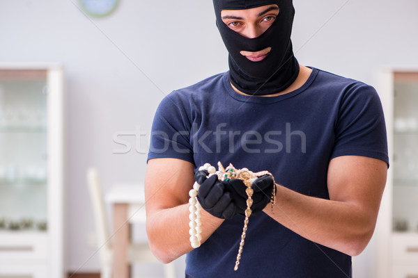 Robber wearing balaclava stealing valuable things Stock photo © Elnur