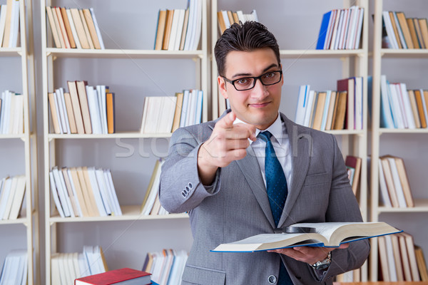 Business law student with magnifying glass reading a book Stock photo © Elnur