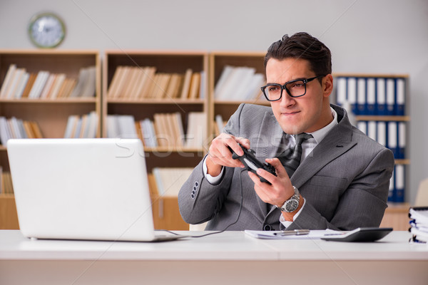 Stock photo: Businessman playing computer games at work office